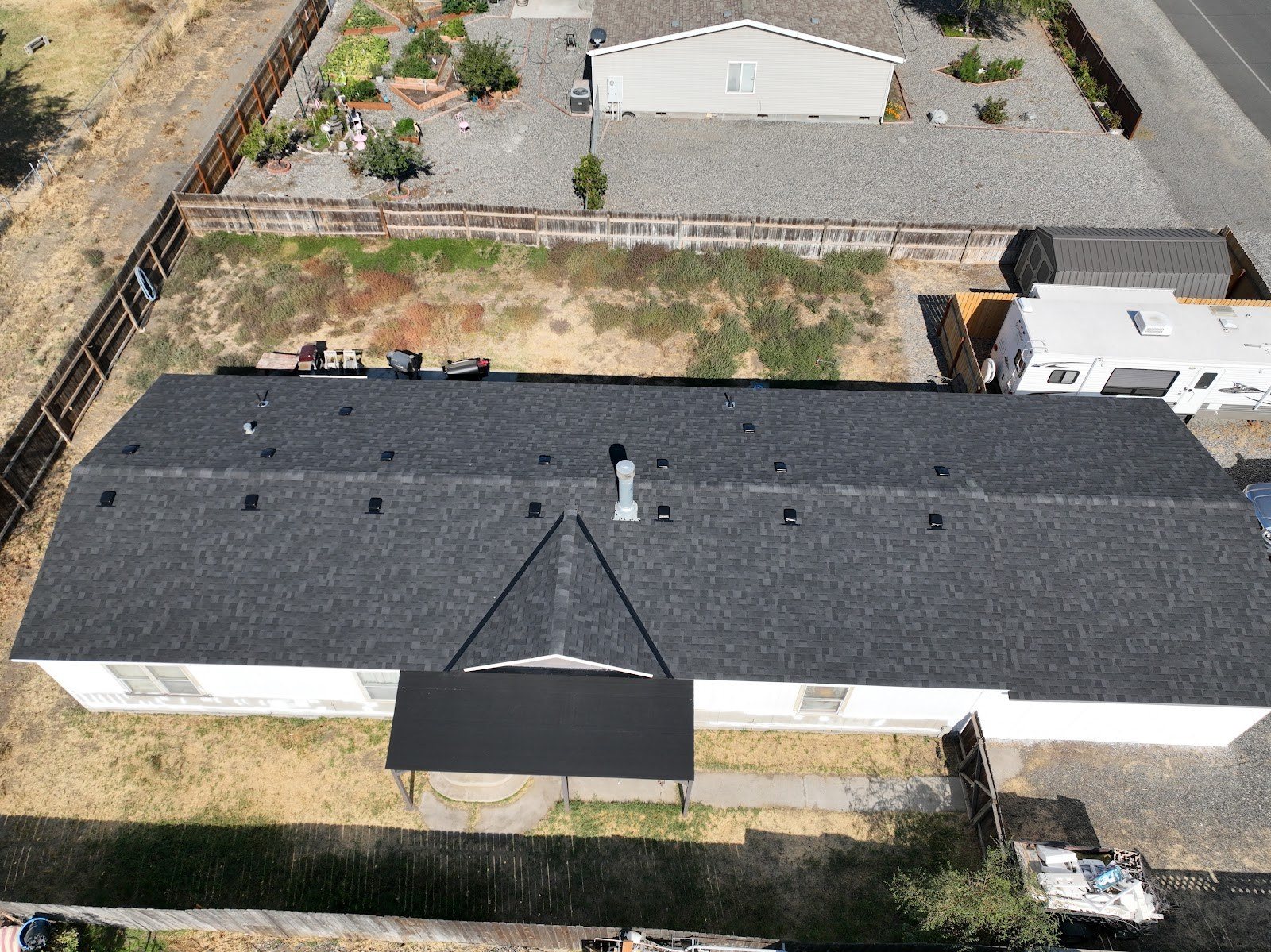 Aerial view of a dark shingle roof on a long single-story home